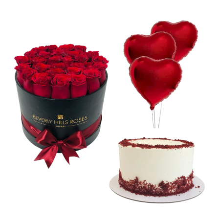 Gift bundle with fresh red roses in a chic box, 3 heart-shaped foil balloons, and a 4-portion red velvet cake, perfect for special occasions in Dubai