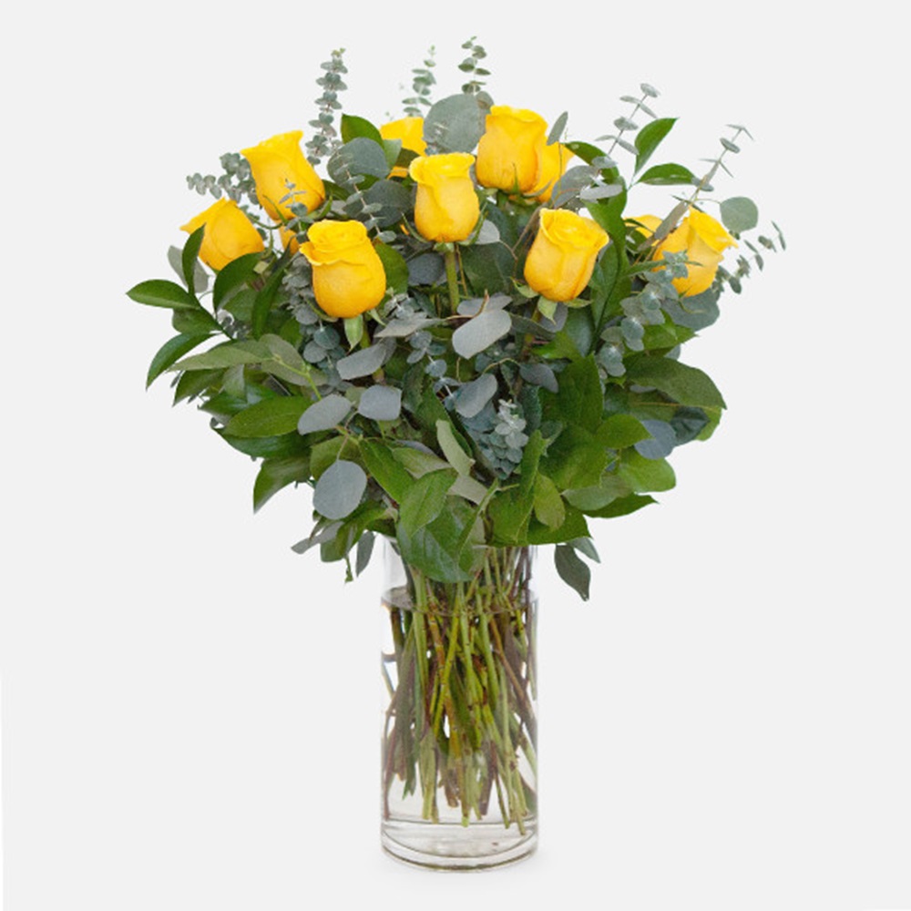 yellow roses in clear glass vase arrangement Dubai